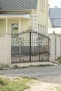 one black metal gate made of iron rods with a forged pattern Royalty Free Stock Photo