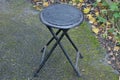 One black round metal chair