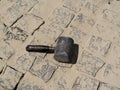 One black rubber mallet lies on a granite paving stones surface - a top view Royalty Free Stock Photo