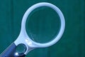 One black white plastic magnifier on a green background Royalty Free Stock Photo
