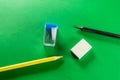 One black and one yellow pencil along with an eraser and a sharpener Royalty Free Stock Photo