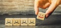 One block with a positive face stands out from the rest of the negative emotions. Concept of good rating, review and feedback.