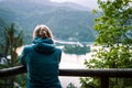 One blonde girl tourist watching a church on the small island in the middle of the Bled lake, Slovenia Royalty Free Stock Photo