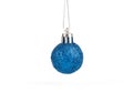 One blue ball Christmas tree toy hangs over a white background. Royalty Free Stock Photo