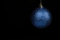 Blue christmas ball on black background