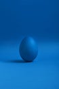 Blue egg on blue background