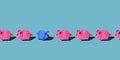 One blue paper pig stands out in the ranks of other pink paper pigs