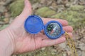 one blue plastic compass lies on an open palm on the hand Royalty Free Stock Photo