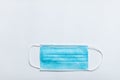 One blue protective medical mask on a white background. Copispace