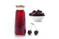 one bottle of cherry juice and fresh cherry on white background Royalty Free Stock Photo