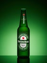 One bottle of Heineken lager beer on green gradient background Royalty Free Stock Photo