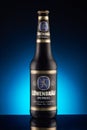 One bottle of Lowenbrau Dunkel beer on dark blue background Royalty Free Stock Photo