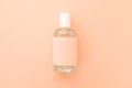 one bottle of perfume against the background of the color of the year 2024 Peach Fuzz