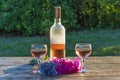 One bottle and two glasses of pink wine, bouquet of roses and la Royalty Free Stock Photo