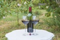 One bottle and two glasses of red wine on white vintage table Royalty Free Stock Photo