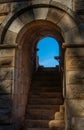 One of the brick arch entrances with granite stairs and door to the steps of the old Roman Theater of Merida. Royalty Free Stock Photo