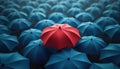 One bright red umbrella stands out among many blue ones in pattern. Image individuality, difference, unique style. Represents one Royalty Free Stock Photo