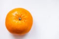 One bright ripe orange glossy tangerine in orange peel on white background. View from above. Top view Royalty Free Stock Photo
