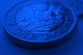 1 one British pound coin close-up. Deep blue background or backdrop on an economy, business, financial or banking theme. Dark Royalty Free Stock Photo