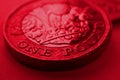 1 one British pound coin close-up. Deep red background or backdrop on an economy, business, financial or banking theme. Dark Royalty Free Stock Photo