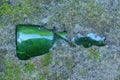 one broken green glass bottle in the gray ground Royalty Free Stock Photo