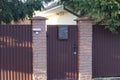 One brown closed metal door with a gray mailbox Royalty Free Stock Photo