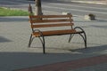 One brown empty bench made of wooden boards and black iron Royalty Free Stock Photo