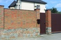 One brown metal mailbox hanging on a red brick wall Royalty Free Stock Photo