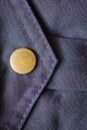 one brown metal rivet button on blue fabric pocket