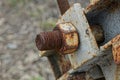 One brown rusty bolt with nut on a gray iron plate Royalty Free Stock Photo
