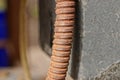 One brown rusty iron gas pipe on a gray concrete wall Royalty Free Stock Photo