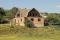 one brown unfinished brick house with empty windows and a black wooden attic Royalty Free Stock Photo