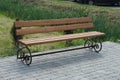 one brown wooden bench of gray on the sidewalk Royalty Free Stock Photo