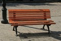 One brown wooden empty bench stands on a gray sidewalk Royalty Free Stock Photo