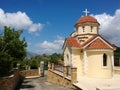 One of the buildings of the monastery in the village of Spili on the island of Crete and the street next to it