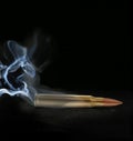 One bullet with smoke on black background Royalty Free Stock Photo