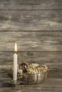 One burning advent candle on wooden christmas background.