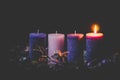 One burning candle on advent wreath