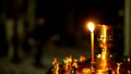 One burning candle close up in a Golden candlestick located in the Orthodox Church