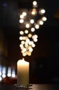 One candle with powerful blurry light reflections Royalty Free Stock Photo