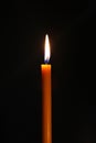 One candle burning brightly in the dark Royalty Free Stock Photo