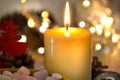 One candle burning brightly in the dark against a background of blurry lights. Romance, festive evening Royalty Free Stock Photo