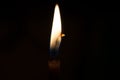 One candle flame at night closeup - isolated, macro Royalty Free Stock Photo