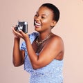 One capture, one hundred reasons, one thousand memories. Studio shot of a beautiful young woman using a camera against a Royalty Free Stock Photo