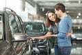 It is the one car I want! Beautiful young couple standing at the Royalty Free Stock Photo