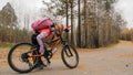 One caucasian children walk with bike in autumn park. Little girl walking black orange cycle in forest. Kid goes do bicycle sports Royalty Free Stock Photo