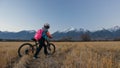 One caucasian children walk with bike in wheat field. Little girl walking black orange cycle on background of beautiful Royalty Free Stock Photo