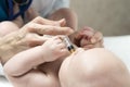 One caucasian female doctor is giving some dose of liquid medicine to infant baby boy by syringe into the mouth from disease or fo Royalty Free Stock Photo