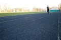 One caucasian male is doing a sprint start. running on the rubber track. Track and field runner in sport uniform. energetic Royalty Free Stock Photo