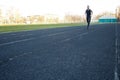 One caucasian male is doing a sprint start. running on the rubber track. Track and field runner in sport uniform. energetic Royalty Free Stock Photo